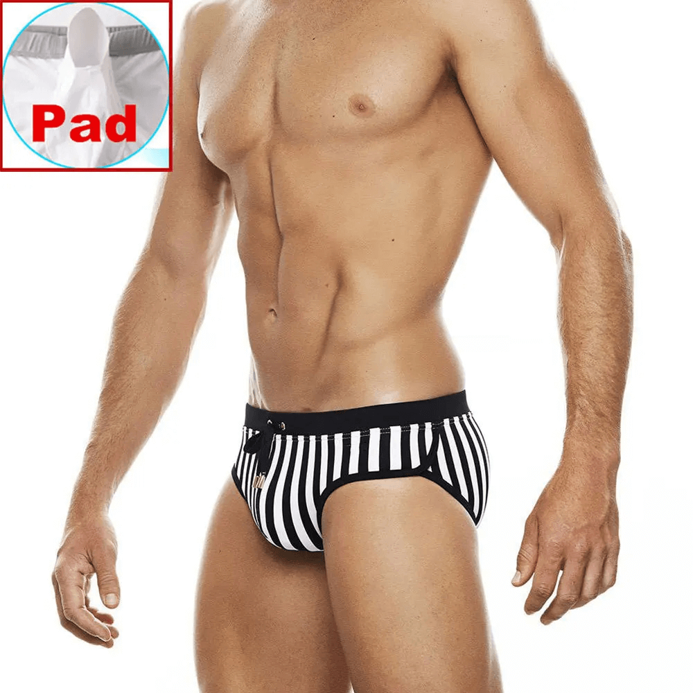Man wearing zebra stripe quick-dry swim briefs, showcasing bold black and white design and comfort for beach or pool.